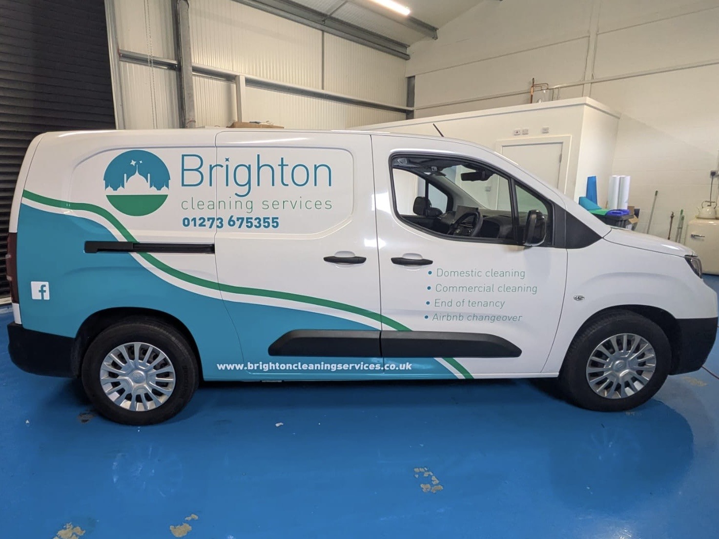 van showing a partial wrap for Brighton Cleaners